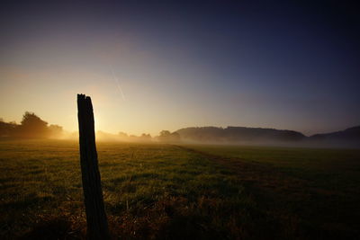 Scenic view of field against sky during sunset