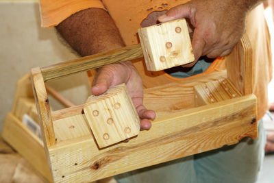 High angle view of man holding wooden container and dices