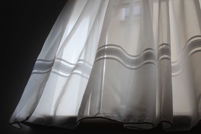 Close-up of curtain against black background