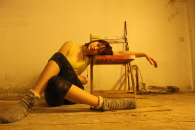 Full length of woman sitting on floor