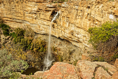 View of waterfall along rocks