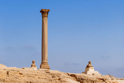 Pompey pillar, roman triumphal column, two sphinx statues at the serapeum of alexandria. egypt.