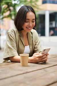 Young woman using laptop at table