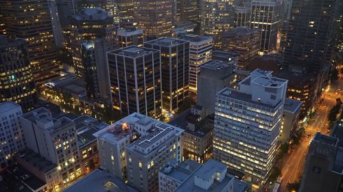 High angle view of city lit up at night