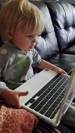 Child uses laptop at home 