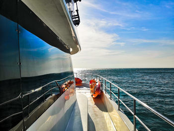 People sailing on sea against sky