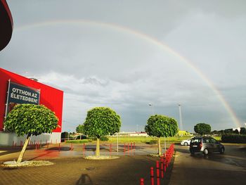 Panoramic view of rainbow over city against sky