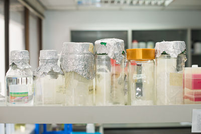 Close-up bottles on rack in laboratory