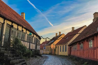 Street amidst buildings in town against sky