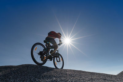 Man riding bicycle on sunny day