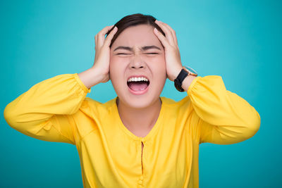 Young woman against blue background