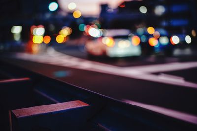 Defocused image of illuminated lights on road at night