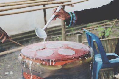 Cropped hands pouring batter on pancake