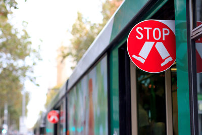 Close-up of road sign against sky