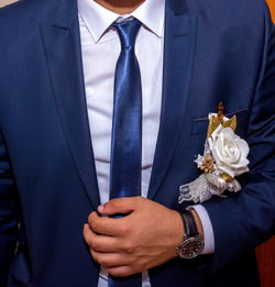 Midsection of man wearing suit