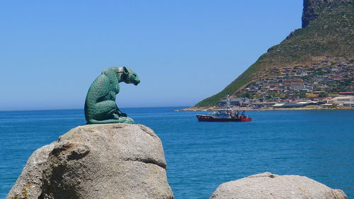 Scenic view of sea against clear blue sky