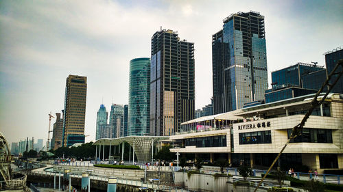 View of skyscrapers against cloudy sky