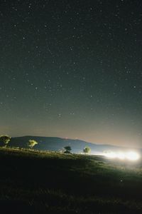 Scenic view of sea against star field at night