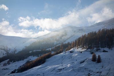 Scenic view of snowcapped mountains against sky