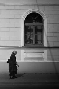 Rear view of woman against building