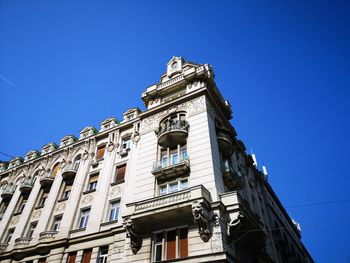 Low angle view of old building against blue sky