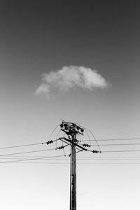 Low angle view of electricity pylon against sky