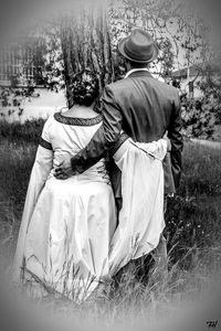 Rear view of couple on field