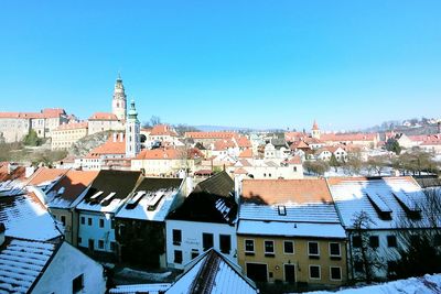 High angle view of houses in town against clear sky