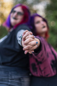 Portrait of young women holding hands