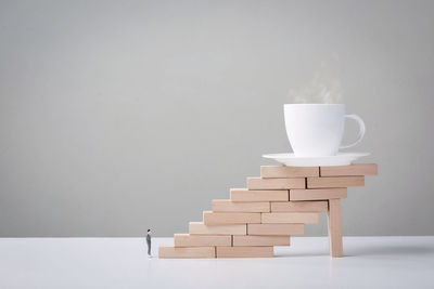 Coffee cup on table against white background