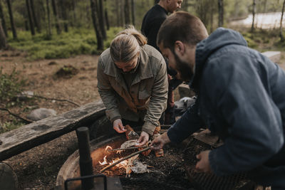 Couple preparing food on barbecue