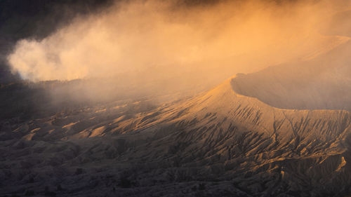 Scenic view of land against sky during sunset