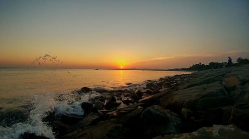 Scenic view of sea against sky during sunset