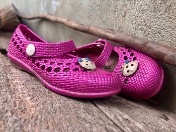 High angle view of pink shoes on wood