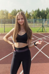 Portrait of young woman exercising in gym