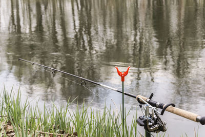 Red fishing rod by lake