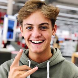 Close-up portrait of smiling young man gesturing