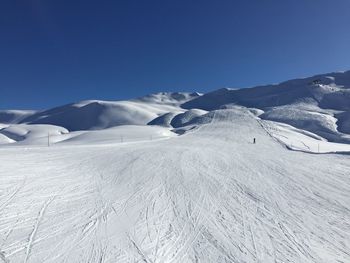 Scenic view of mountains against clear blue sky