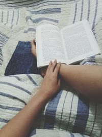 Low section of woman reading book