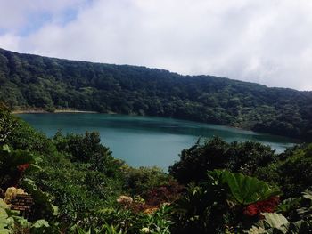 Scenic view of lake and mountains against sky