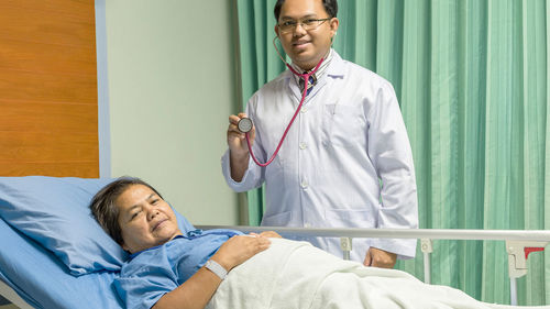 Portrait of doctor and patient in hospital ward