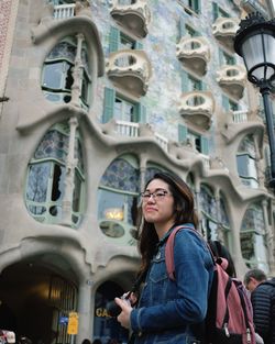 Portrait of young woman looking away in building