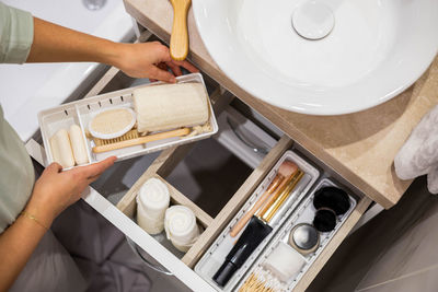 Midsection of woman holding personal accessories