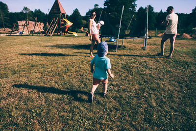 Full length of children on field