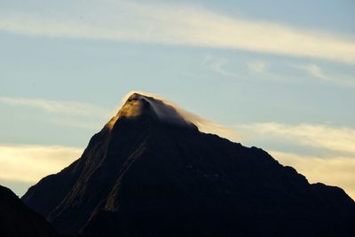 Scenic view of mountains against cloudy sky