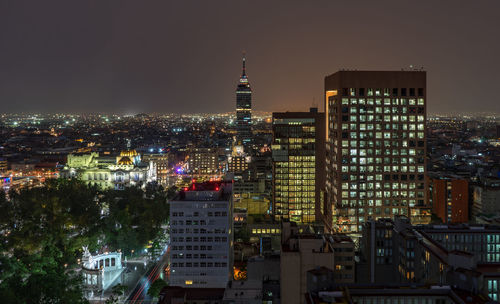 Torre latinoamericana amidst buildings in city at night