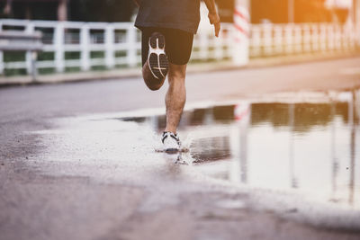 Low section of man running on water