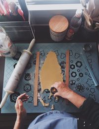 High angle view of man cutting cookie dough