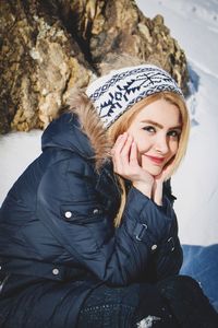 Portrait of smiling young woman in snow