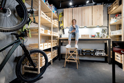 Portrait of woman standing on bicycle